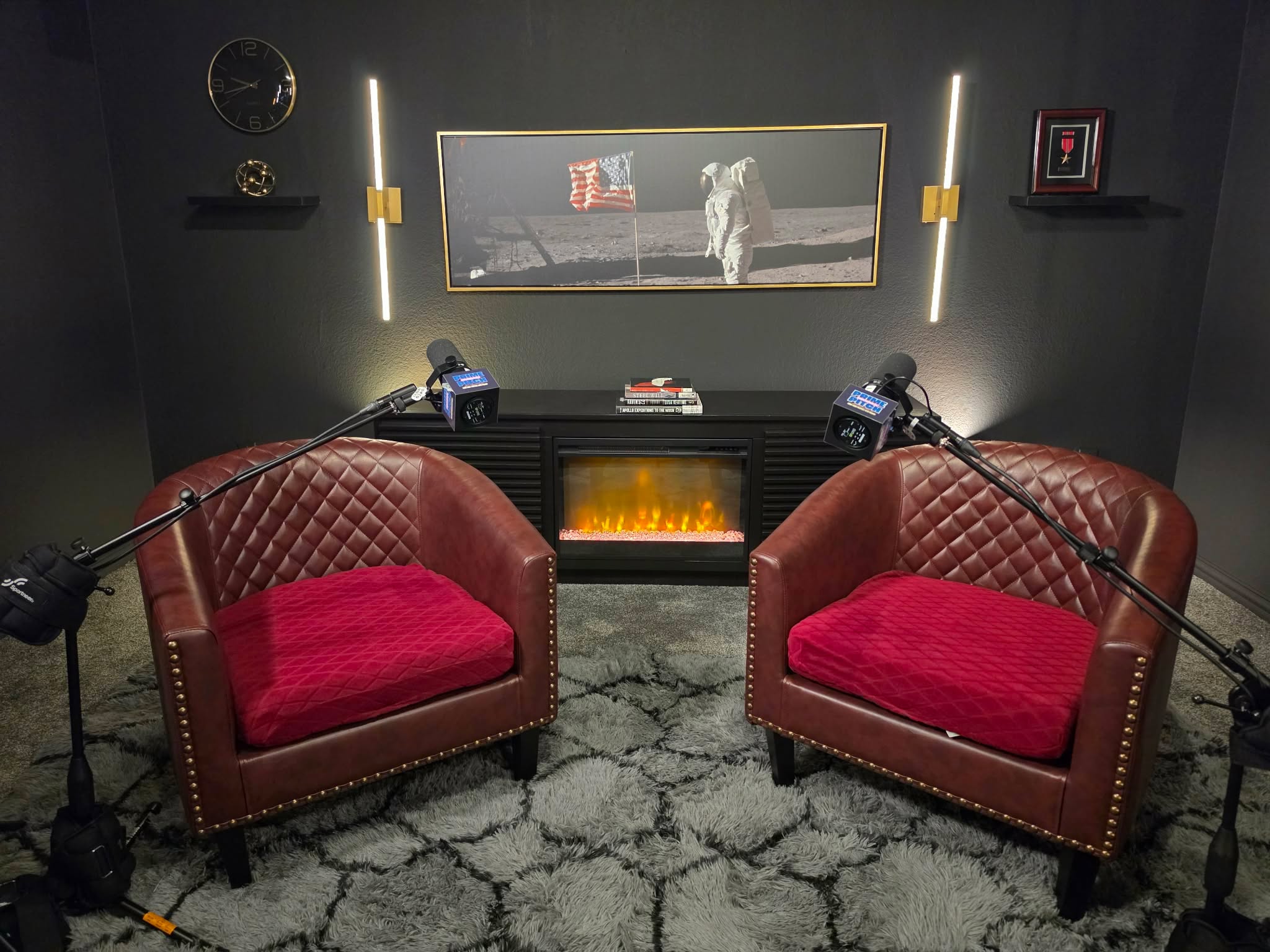 The Prime Pitch studio — the two-chair set beneath the Apollo 11 print